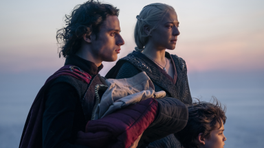 A still from "House of the Dragon." Rhaenyra Targaryen (Emma D'arcy) and her children stand near the sea.