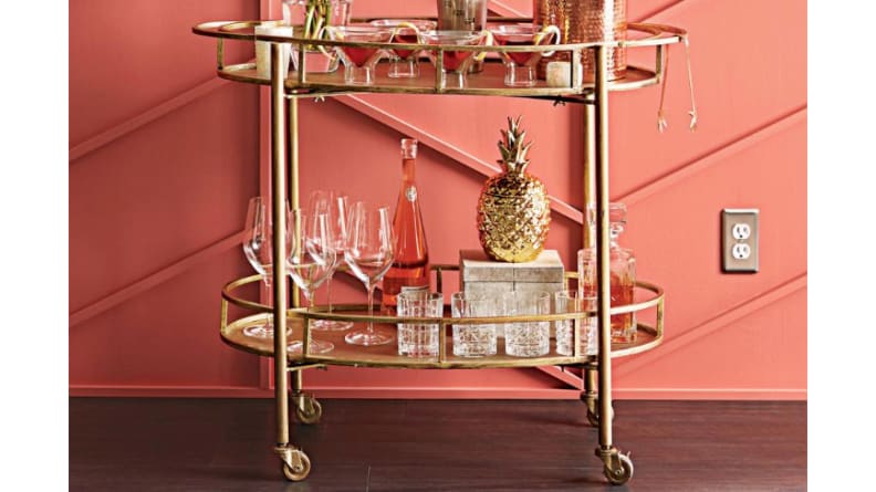 A gold Eliza bar cart