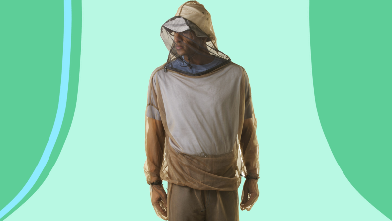 Person wearing mesh netting as a pullover poncho with hood.