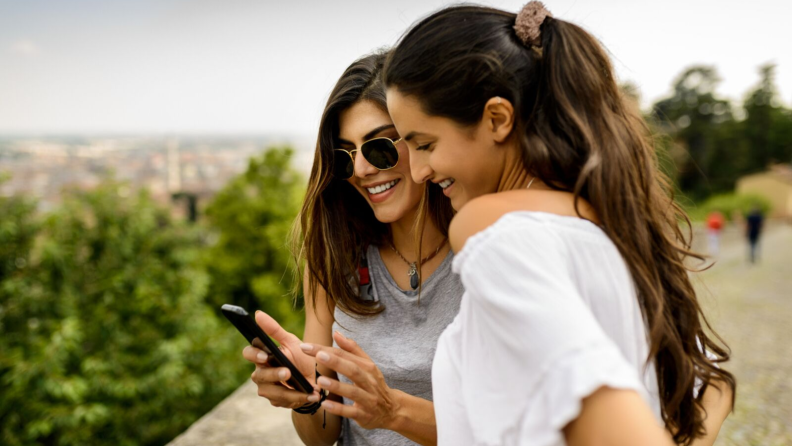Two girls looking at one smartphone