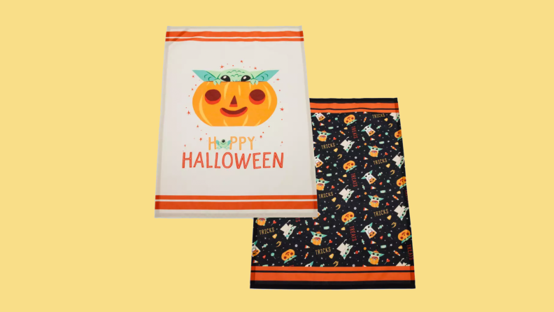 Two Grogu-themed towels on an orange background