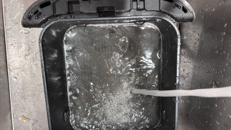 Water running into the basket of the Ninja Double Stack XL Air Fryer.