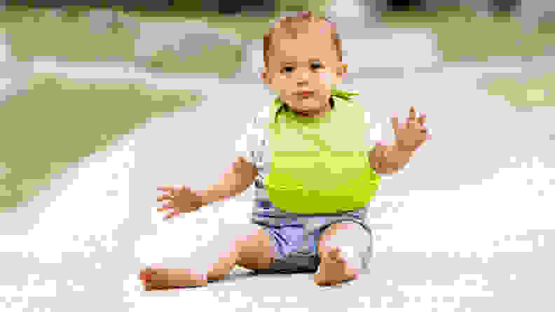 Baby wearing OXO Tot roll-up bib