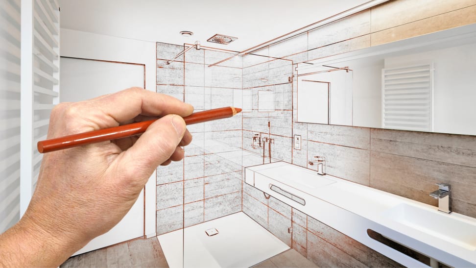 An architect draws plans for a bathroom renovation