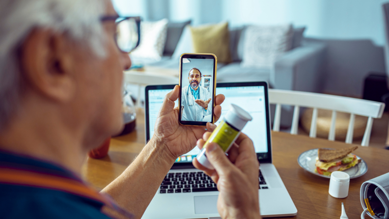 Senior man consulting with a doctor on his phone.