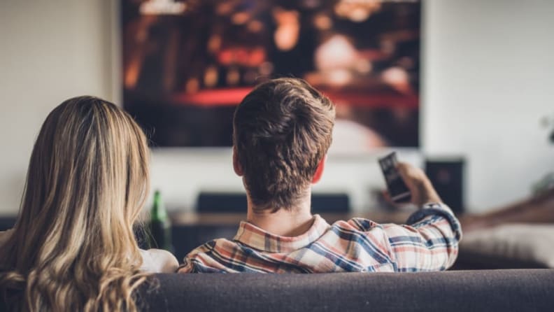 couple watching streaming service on couch