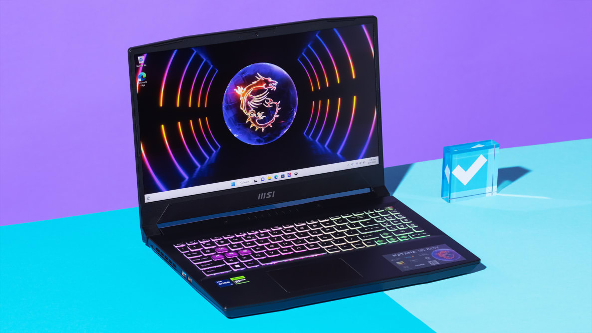 An open and powered on black laptop with a neon-lit keyboard against a purple and blue backdrop.