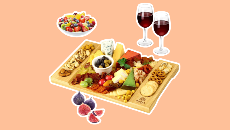 A wooden charcuterie board filled with assorted fruits, nuts, crackers and cheeses.