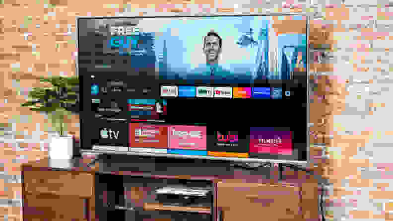 The Amazon Fire TV Omni displaying its smart platform's home screen in a living room setting