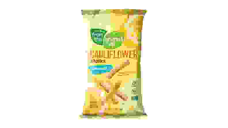 A bag of cauliflower chips with mostly yellow colors and some green accents.