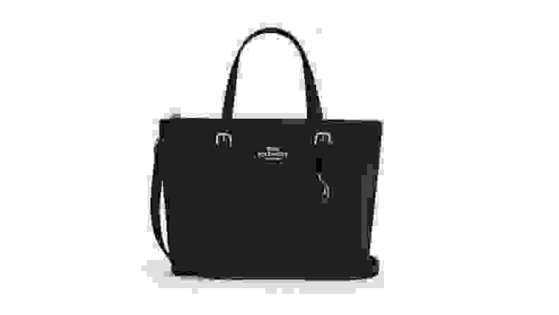 A black Coach bag against a white background.