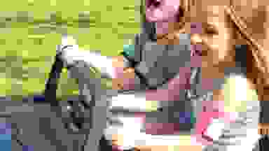 Closeup of children driving the buggy