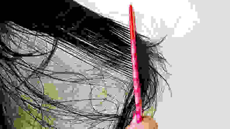 A woman's hair tangled in a brush.