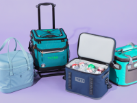 Four soft coolers sitting together against a purple background