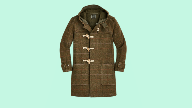 A wool duffel coat against a green background.