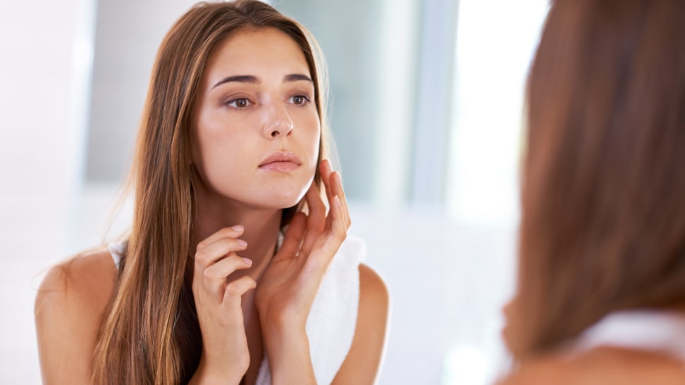 Woman touching her face.