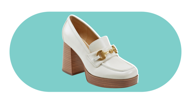 A white, high-heeled loafer. The shoe has a stacked wooden heel along with gold hardware.