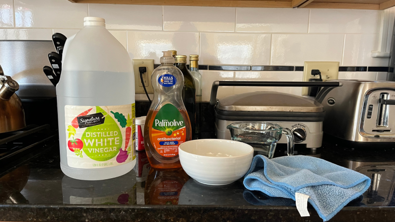 Cleaning products sitting on a kitchen counter.