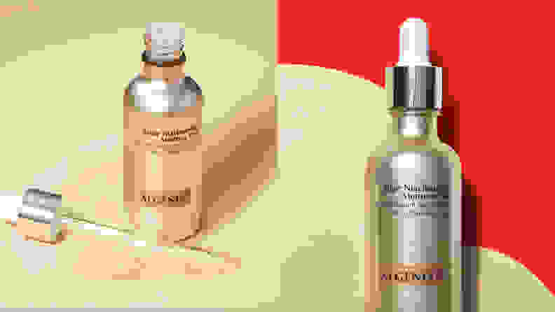 On the left: The gold Algenist Algae Niacinamide Moisture Veil bottle stands on a cream background with the dropper off to the side and a swatch of the gold liquid spilling out of it. On the right: The gold Algenist Algae Niacinamide Moisture Veil on a red background with a giant swatch of the gold liquid behind the bottle.