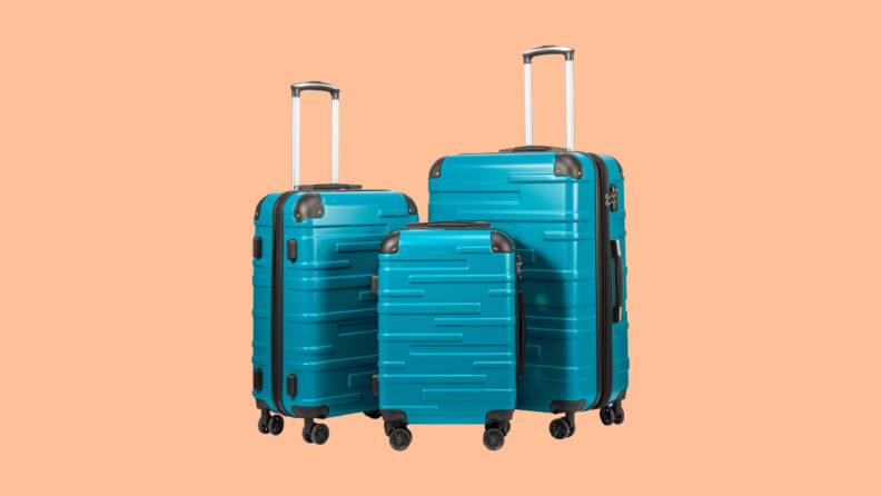 Three blue suitcases of differing sizes against orange background