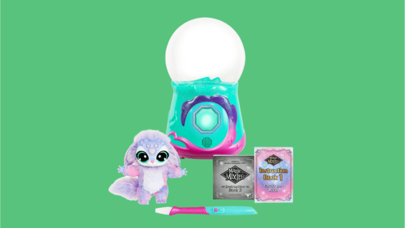 a toy crystal ball with a teal blue and pink base next to a furry animal toy.