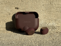 The Jabra Elite 10 and the carrying case in an outdoor pavement.