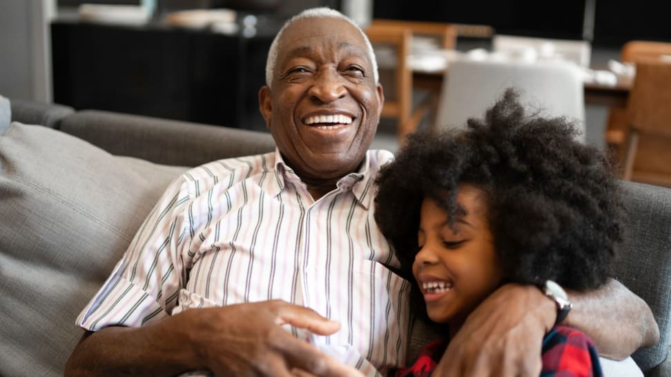 Grandfather with his granddaughter on couch