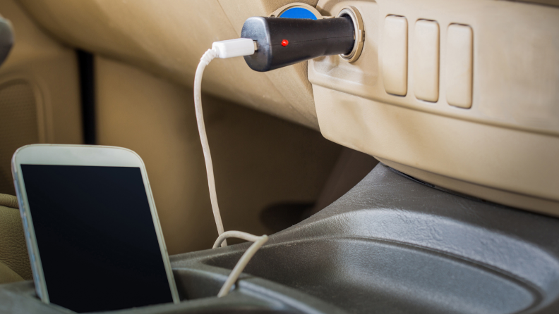 Charing an iPhone in car with tan interior using a car charger