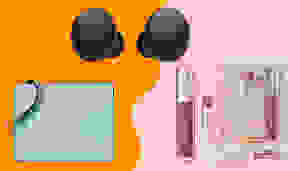 light blue wristlet, black earbuds and lip balm duo on an orange/pink background.