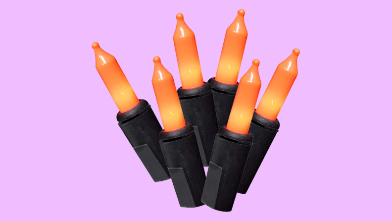 An image of a set of orange and black string lights bunched up together.