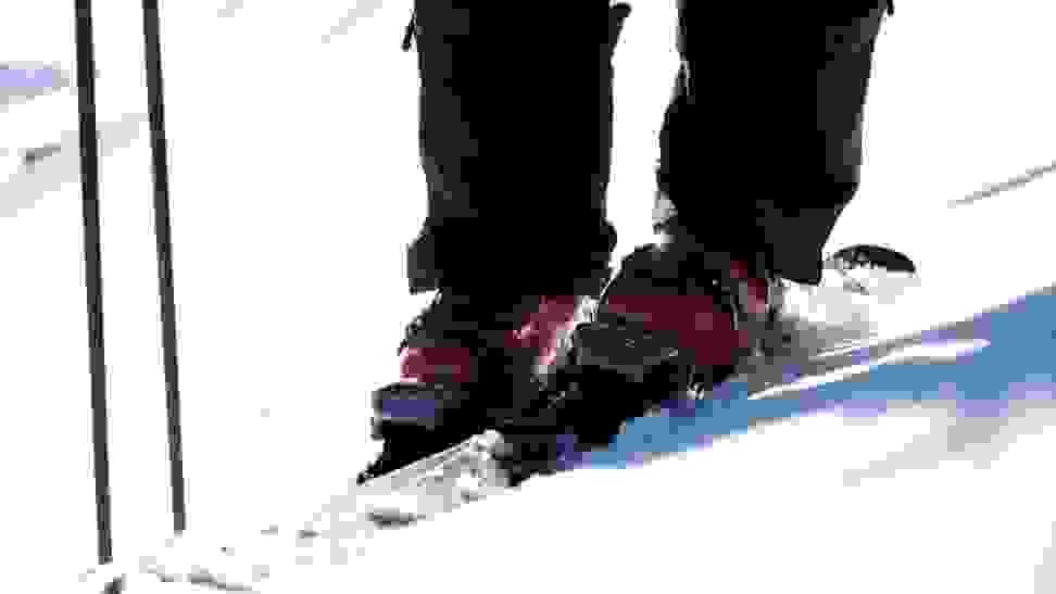 Photo of a pair of Tecnica ski boots in use out on the slopes.