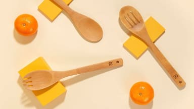 A set of wooden spoons on a kitchen table that are about to be used to cut fruit.