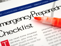 Paper labeled "emergency preparedness checklist" with an orange highlighter on top