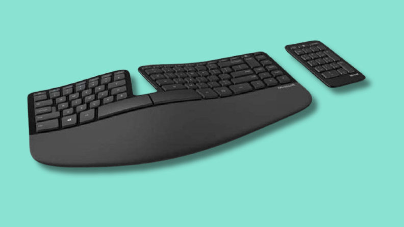 The Microsoft Sculpt Ergonomic Keyboard on a green background.