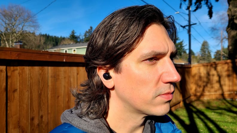 A Reviewed editor listens to music outdoors with the Samsung Galaxy Buds Pro.