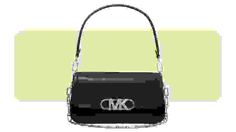 A leather shoulder bag with a chain and leather strap and silver hardware.