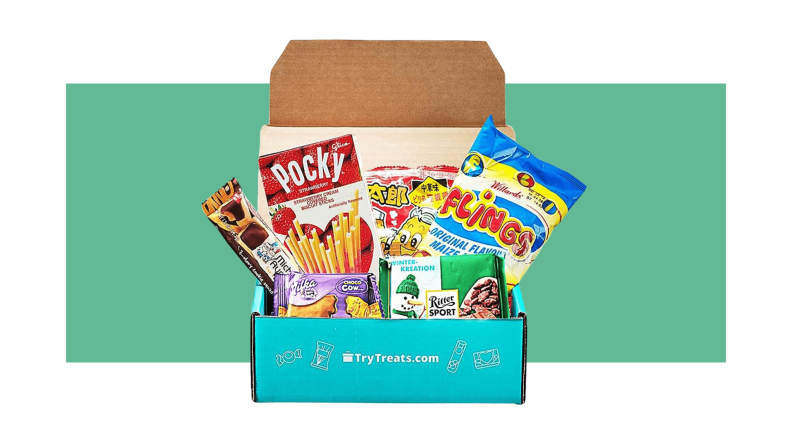 Blue cardboard box with lid open to reveal assorted snack packages.