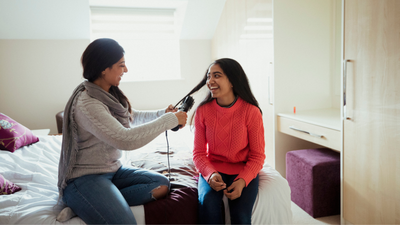 Mother and daughter bonding while mother does hair