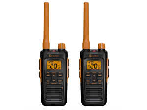Two Cobra walkie-talkies held in hand with a lake in the background