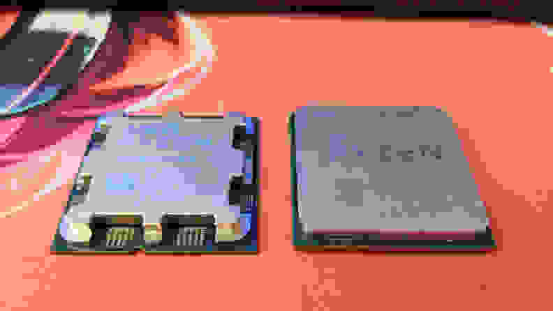 Two computer processors side by side, right side up, on top of a mat.