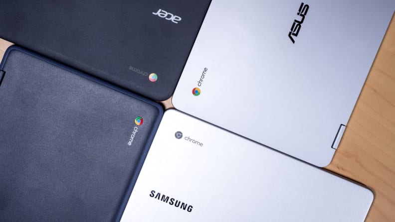 4 laptops making a clover pattern on a desk