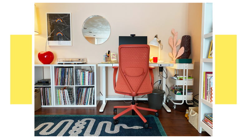 Coral colored Verve Chair stationed at desk inside of modern home office.