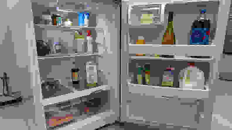 A close-up of the interior of the fridge, sitting next to other fridges in our testing lab. The door is open, revealing a fully-stocked interior and door bins.