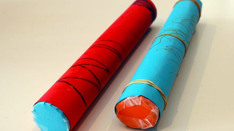 Two rain sticks made from construction paper and paper towel rolls