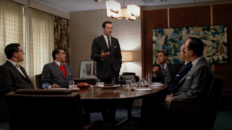 Several men in a meeting in Mad Men.