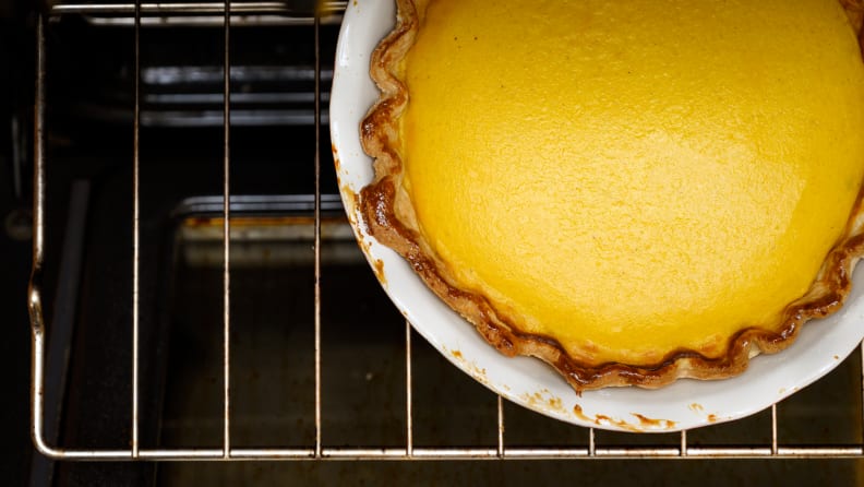 A pie baking in an oven, shot from above.