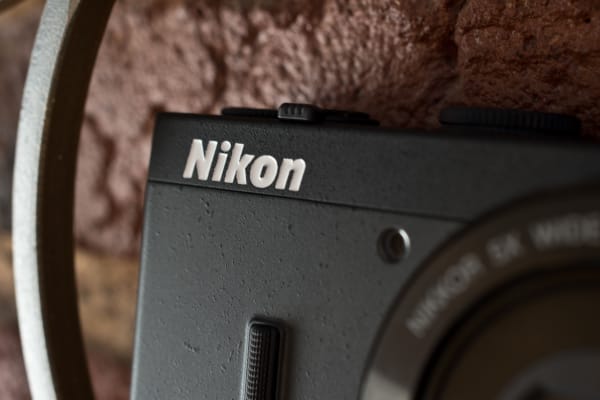 A photograph of the Nikon Coolpix P340's front logo, AF lamp.