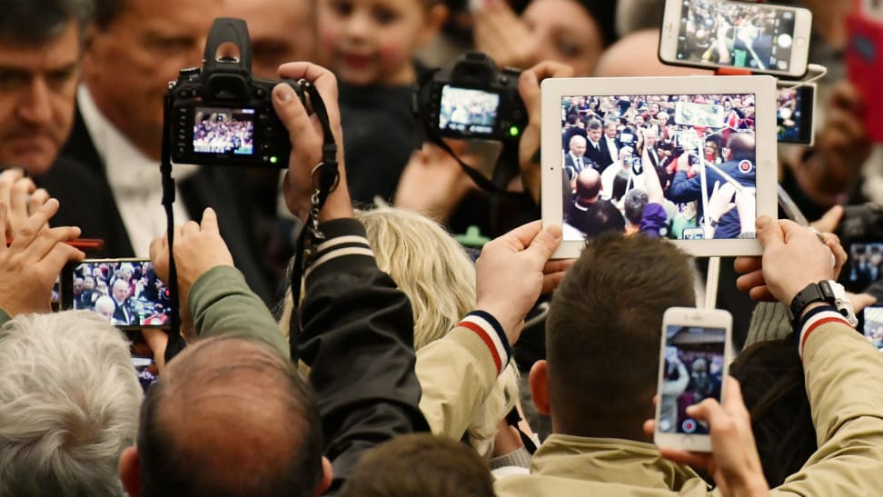 People rise their mobiles, tablets and cameras as Pope Francis arrives for his weekly general audience at the Paul VI audience Hall on December 7, 2016 in Vatican.