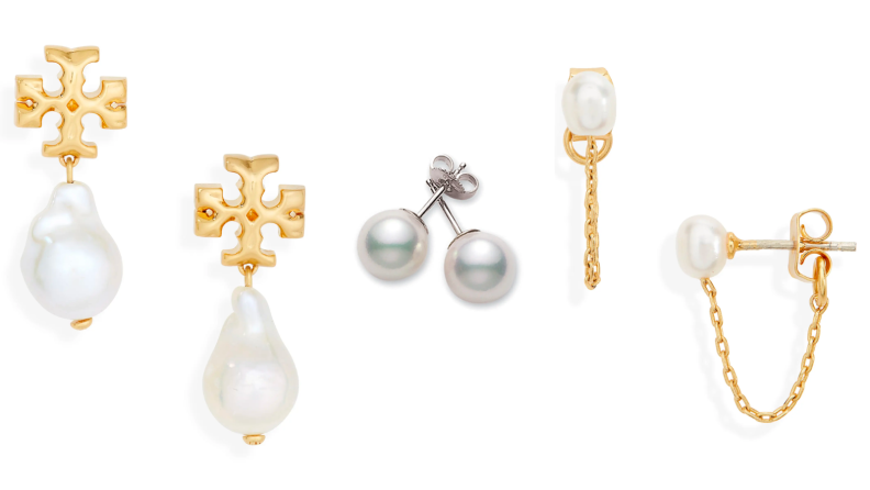 Three different pairs of pearl earrings, including a pair of freshwater pearl earrings with golden cross studs, a pair of plain Akoya pearl studs, and freshwater pearl studs on gold posts with a connecting gold chain.
