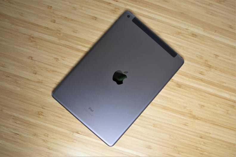 An Apple iPad face-down on a desk.